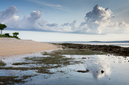 Tropical sunset at low tide. Gili Pentangan island, Lombok, Indonesia.の写真素材