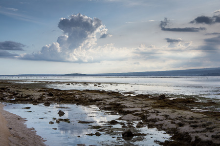 Tropical sunset at low tide. Gili Pentangan island, Lombok, Indonesia.の写真素材