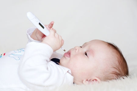 The baby with an electronic thermometer の写真素材