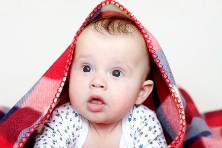 The four-months baby covered by a checkered plaid の写真素材