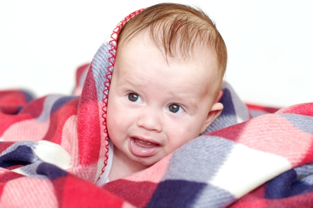 The crying baby covered by a checkered plaid の写真素材