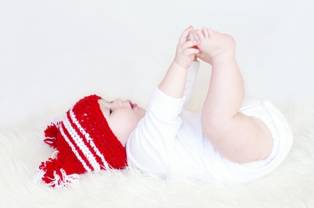 The baby touches his foots の写真素材