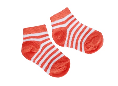 orange striped baby socks on white background