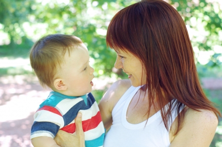 mother and son age of 9 months walking in parkの写真素材