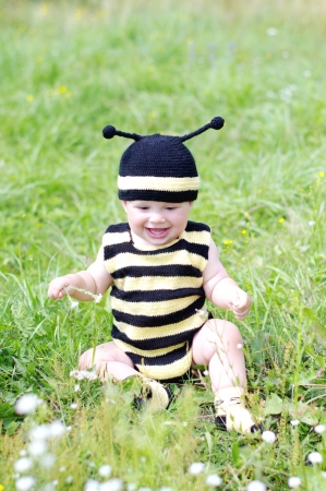 baby age of 10 months in bee costume outdoorsの写真素材