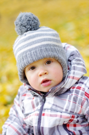 portrait of lovely baby age of 1 year outdoors in autumnの写真素材