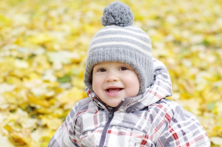 portrait of lovely smiling baby age of 1 year outdoors in autumnの写真素材
