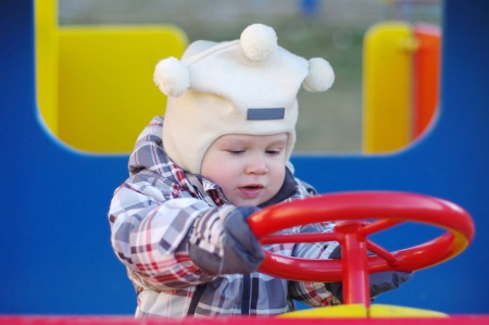1 year baby driving car on playgroundの写真素材