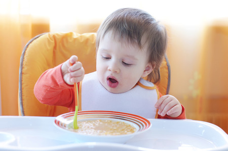 baby eating soupの写真素材