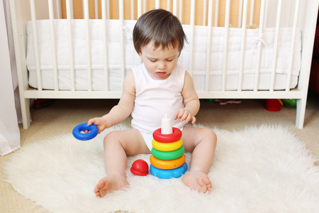 lovely 18 months baby plays nesting blocksの写真素材