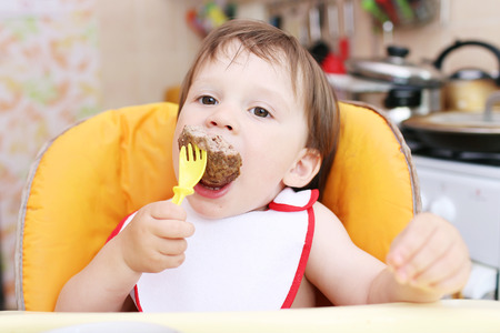 baby age of 20 months eating meatの写真素材