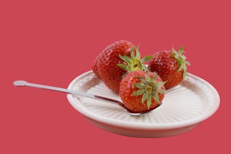 strawberries on a plate with spoonの写真素材