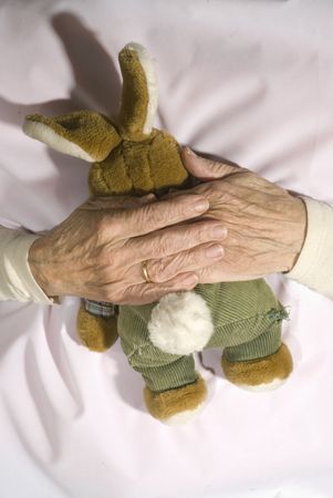 Old demented person with stuffed rabbitの写真素材