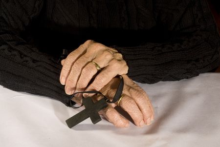 old hands with simple black cross