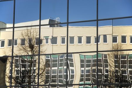 modern office building mirrored in glass