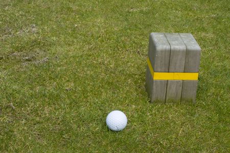 golf ball in the grass near golf attributeの写真素材