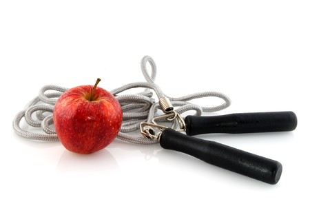 exercise with skipping rope and diet with an red appleの写真素材