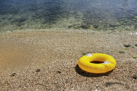 Yellow floating toy at the beachの写真素材