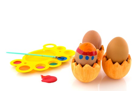 Painting easter eggs with brush and colored paint