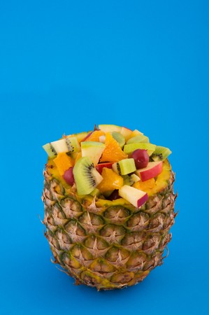 Fruitcocktail in pineapple on blue backgroundの写真素材