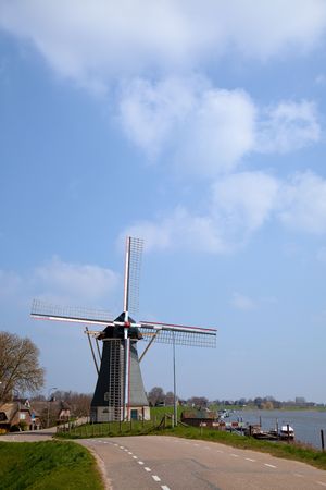 Dutch Windmill in river landscape