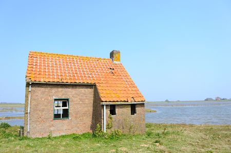 Water landscape in Holland with uninhabitable houseの写真素材