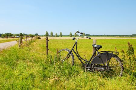 Typical Dutch an old bike in Hollands landscapeの写真素材