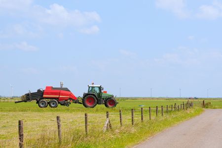 Typical Dutch landscape with tractor and farmland