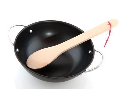 Black wok with wooden spoonの写真素材
