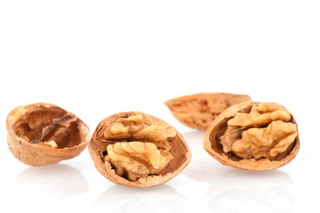 Several open filled walnuts isolated over white