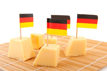German cubes cheese with flags isolated over whiteの写真素材