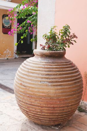 Typical Greek vase with pink bougainvillaea flowersの写真素材