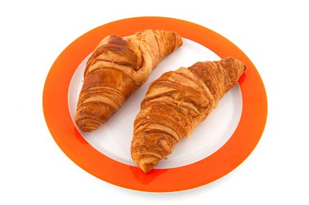 French bread rolls croissants on plate isolated over whiteの写真素材