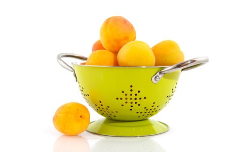 Yellow prunes in colanderの写真素材