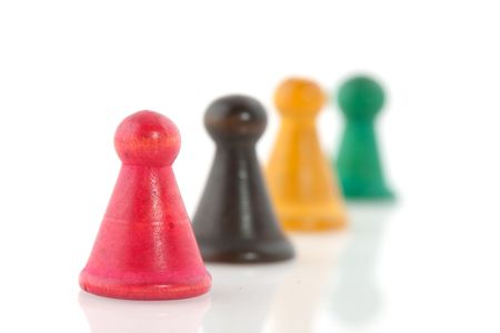 Four vintage pawns in different colors isolated over whiteの写真素材