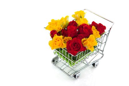 shopping cart with red and yellow rosesの写真素材