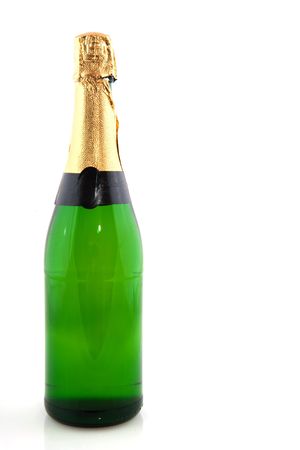 Green bottle champagne with golden paper isolated over whiteの写真素材