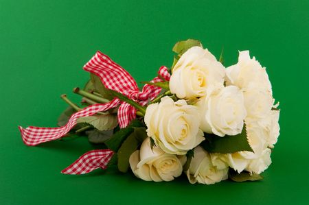 Bouquet of white roses with ribbon on green backgroundの写真素材