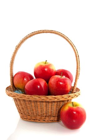 Basket with fresh red apples isolated over whiteの写真素材