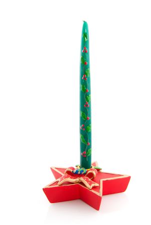 Green christmas candle in candlestick isolated over whiteの写真素材