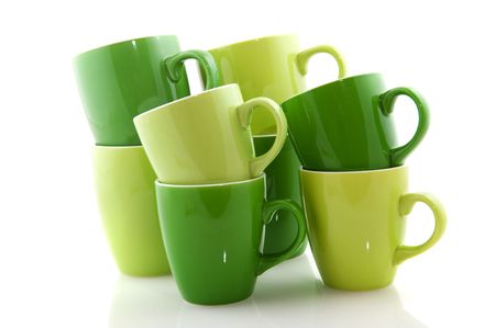 Stacked green mugs in two different colorsの写真素材