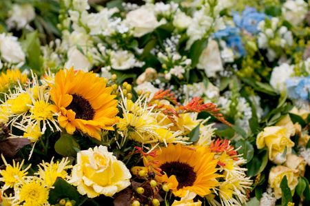 Many different flowers als roses and sunflowers for memoriam