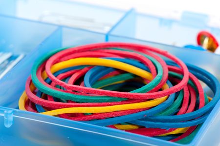 pile of Colorful rubber elastics in blue organizerの写真素材