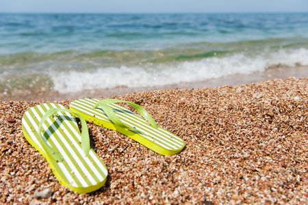 summer vacation with flip flops at the beachの写真素材