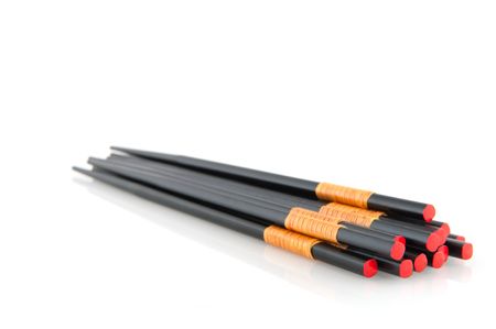 many black chop sticks with bamboo and redの写真素材