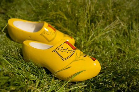 Dutch wooden clogs in the sunny grassの写真素材