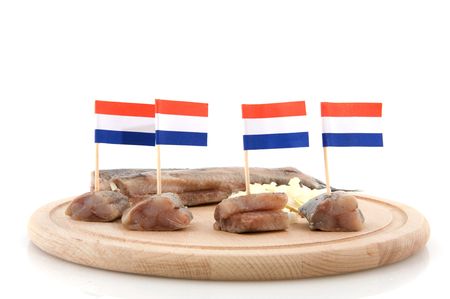 Typical Dutch herring with flags on wooden plateの写真素材