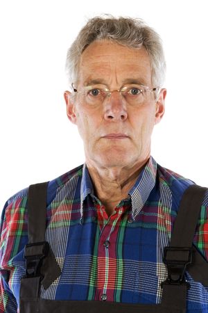 Portrait of a senior working man in dungareeの写真素材