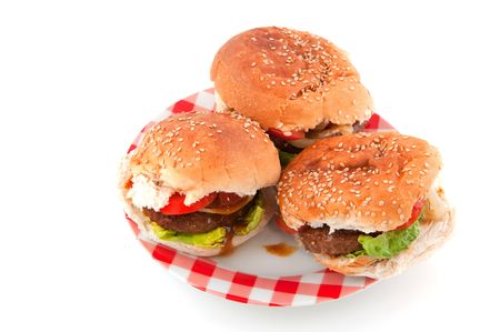 Three hamburgers on a checked plate isolated over whiteの写真素材