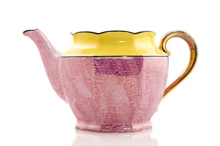 classic tea pot in pink and yellow isolated over whiteの写真素材